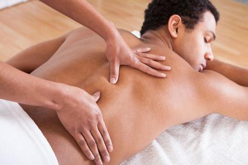 Licensed massage therapist providing therapeutic massage treatment to support pain relief and wellness